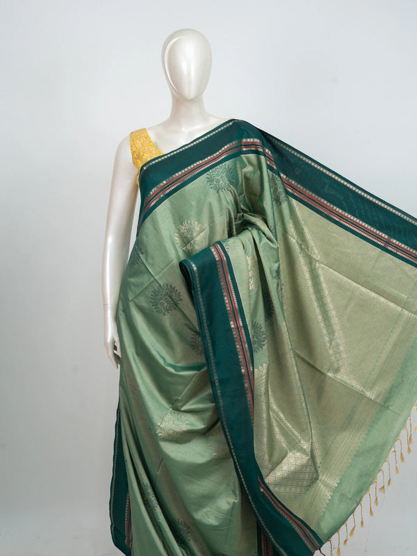 Sage green Kanchipuram fancy silk saree with contrast teal silver zari border and floral butta body