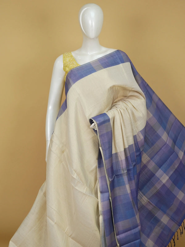 Cream linen cotton saree with blue and purple checked contrast pallu and border