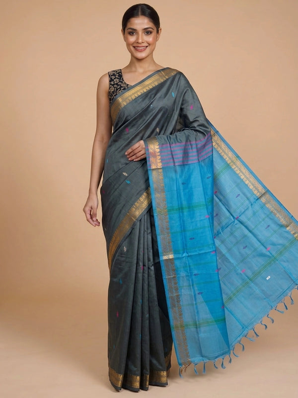 Grey silk saree with contrast blue pallu, gold zari border and black embroidered blouse