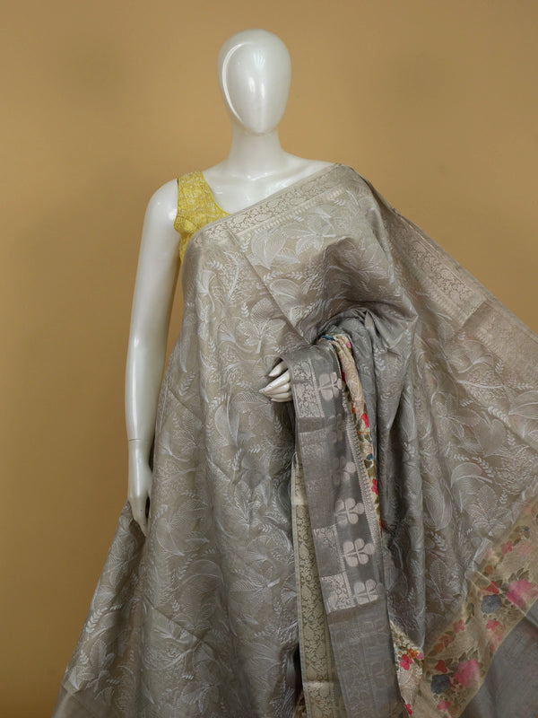 Grey designer saree with white floral embroidery, silver zari border and multicoloured embroidered roses