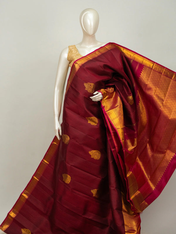 Maroon pure Kanchipuram silk saree with contrast pink and gold zari border and paisley buttas