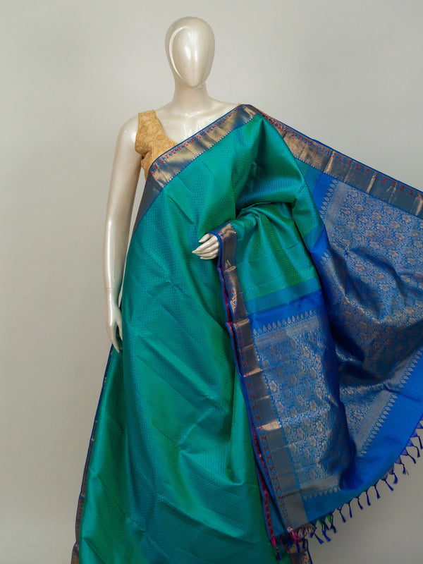 Teal green pure Kanchipuram silk saree with contrast blue and gold zari border and floral zari pallu