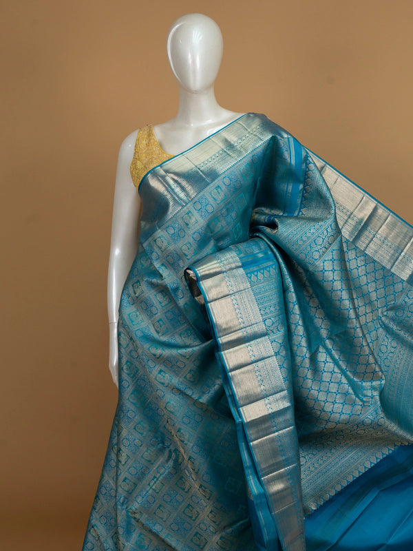 Peacock blue pure Kanchipuram silk saree with silver zari checkerboard motifs, broad zari border and jaali pallu