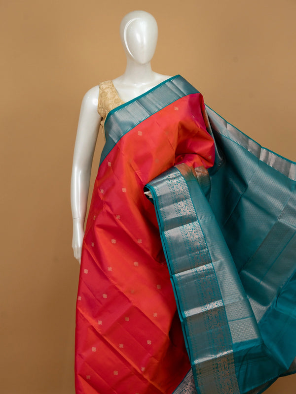 Pink and teal pure Kanchipuram silk saree with silver zari peacock border and gold buttas