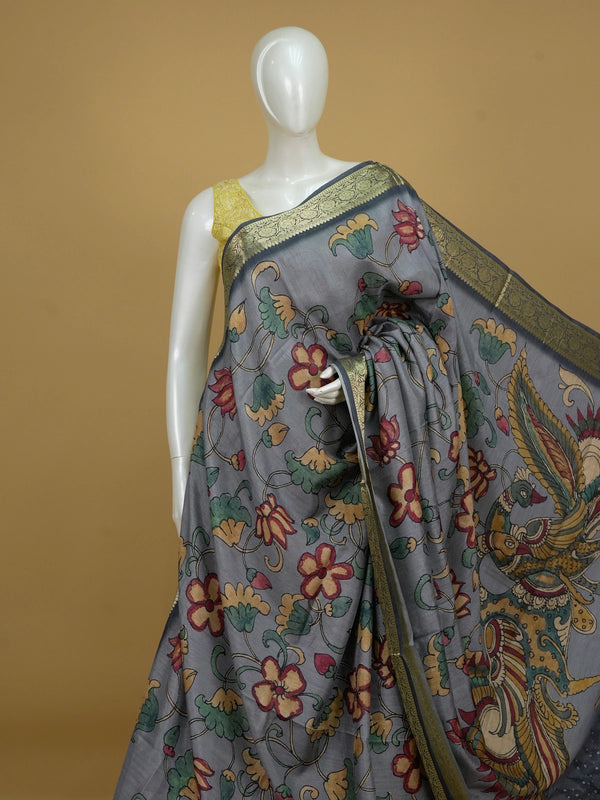 Grey semi tussar saree with Kalamkari floral print, peacock pallu and gold zari contrast border