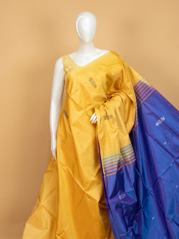 Mustard yellow banana silk saree with royal blue contrast pallu, border and scattered buttas