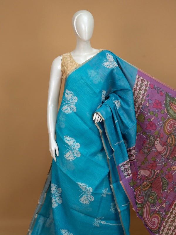 Turquoise blue linen cotton saree with white butterfly prints and a contrast purple Kalamkari pallu