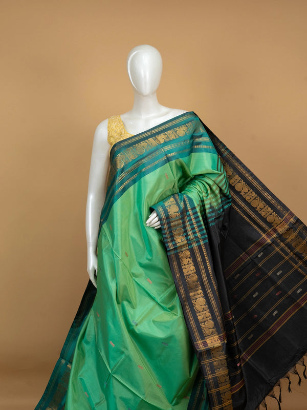 Green and black Banana Silk saree with gold zari peacock border and contrast pallu