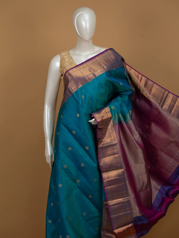 Teal blue pure Kanchipuram silk saree with contrast magenta border and gold zari buttas
