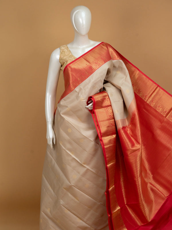 Cream and red pure Kanchipuram silk saree with gold zari border and buttas