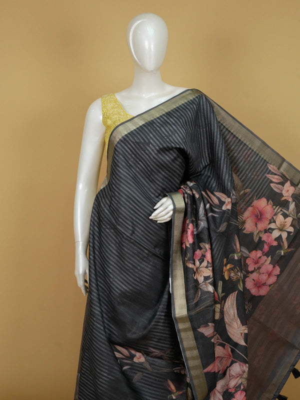 Black semi tussar saree with diagonal stripes, gold zari border and tropical floral hummingbird print pallu