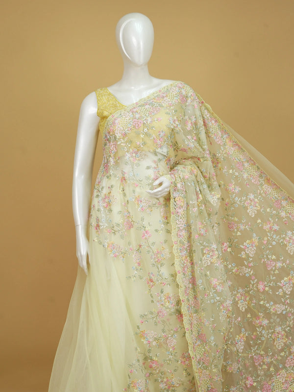 Lemon yellow net designer saree with pastel multicolour floral embroidery and scalloped border