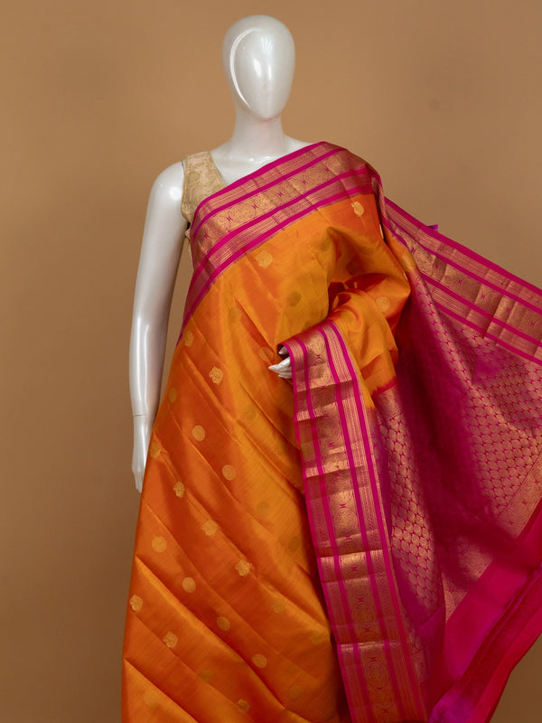 Orange and pink pure Kanchipuram silk saree with contrast gold zari border and buttas
