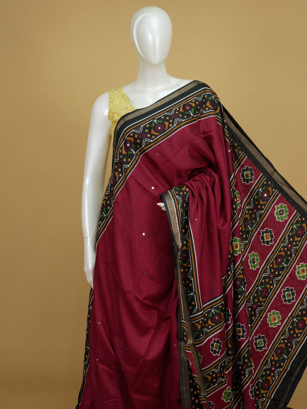 Maroon Dola silk saree with black patola-style border, multicolour pallu and mirror work
