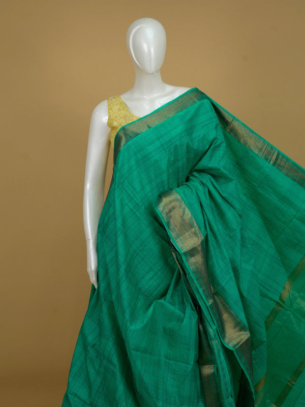 Green semi tussar saree with gold zari border and matching green butta blouse