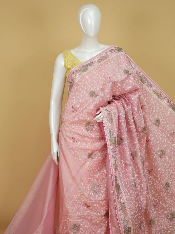 Pastel pink embroidered designer saree with floral jaal, bird and elephant motifs and pom-pom border