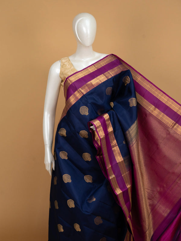 Navy blue pure Kanchipuram silk saree with magenta contrast border and gold zari buta motifs