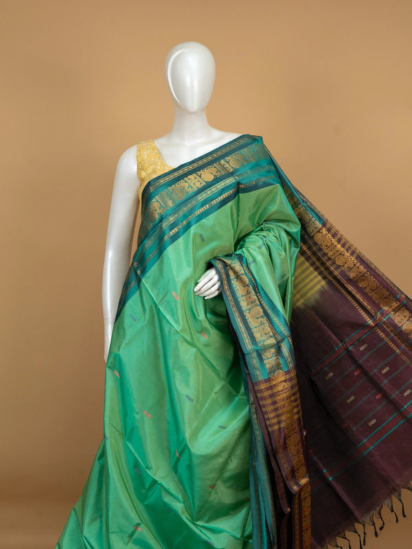 Green banana silk saree with teal gold zari peacock border and contrast maroon pallu