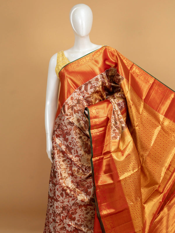 Cream and orange pure Kanchipuram silk saree with floral printed body and gold zari contrast border