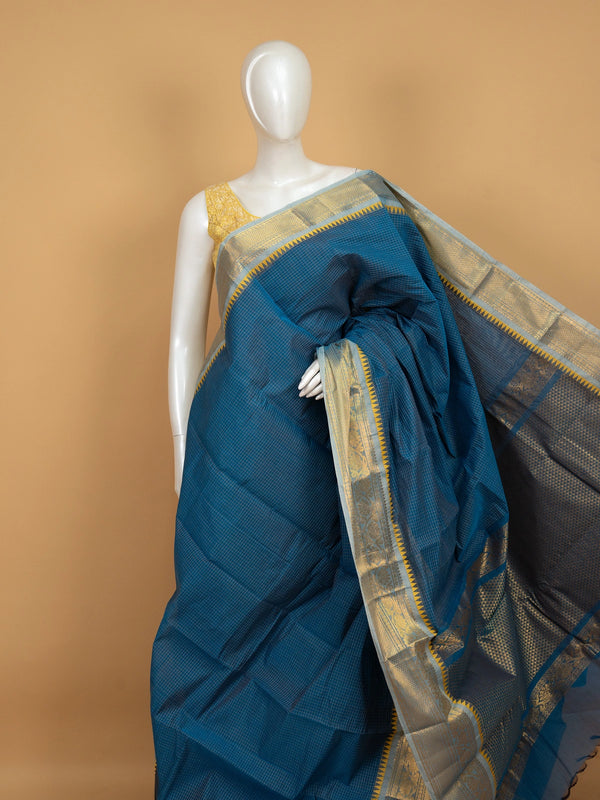 Teal blue Chettinad cotton saree with gold zari temple border, woven checks, and contrast yellow blouse