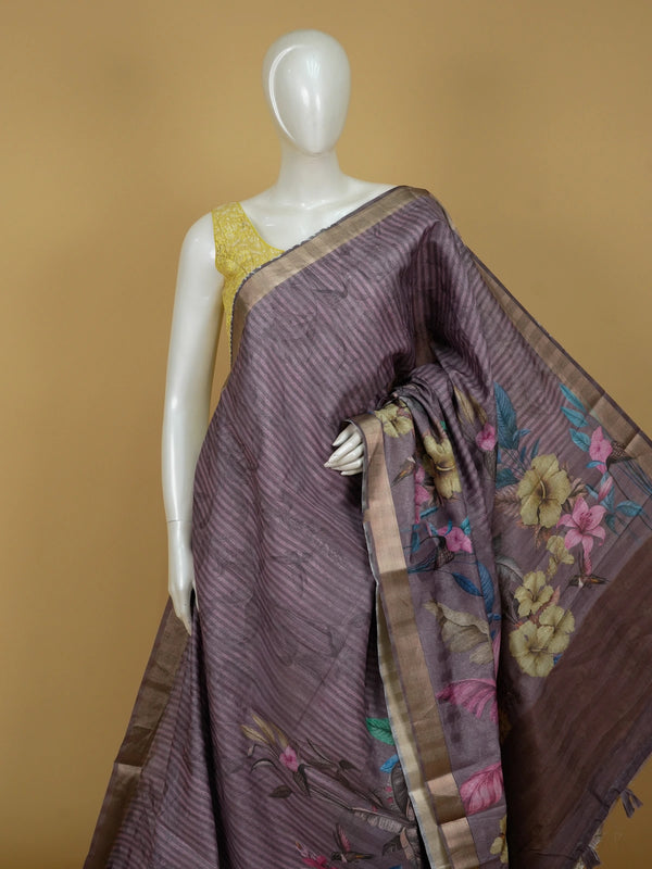 Mauve semi tussar saree with tropical floral printed pallu, gold zari border and contrast yellow blouse