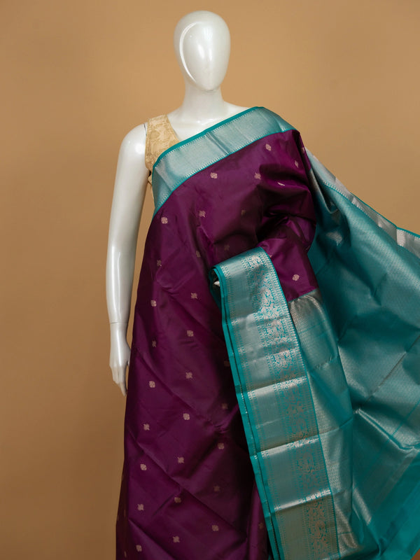 Purple pure Kanchipuram silk saree with teal contrast border and silver zari buti motifs