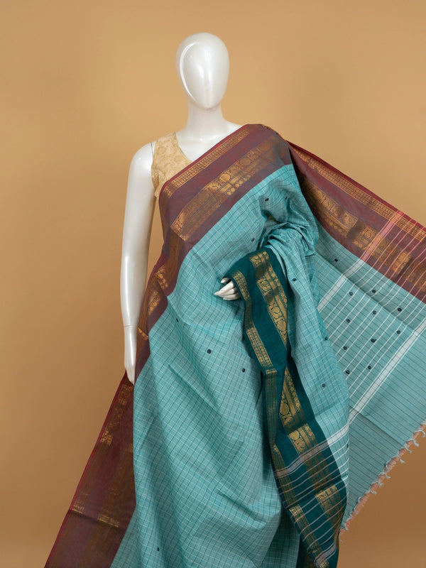 Aqua sea green Chettinad cotton saree with checks, contrast maroon gold zari border and teal peacock pallu