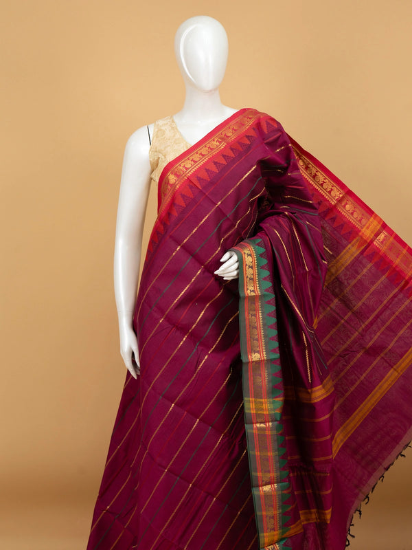 Magenta wine Chettinad cotton saree with red contrast border, gold zari peacock motifs and green temple design