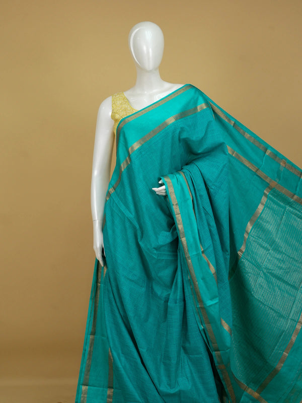 Teal green semi tussar saree with geometric body pattern and gold zari border