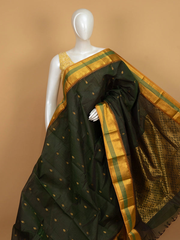 Dark green Chettinad cotton saree with mustard gold zari border and woven floral pallu