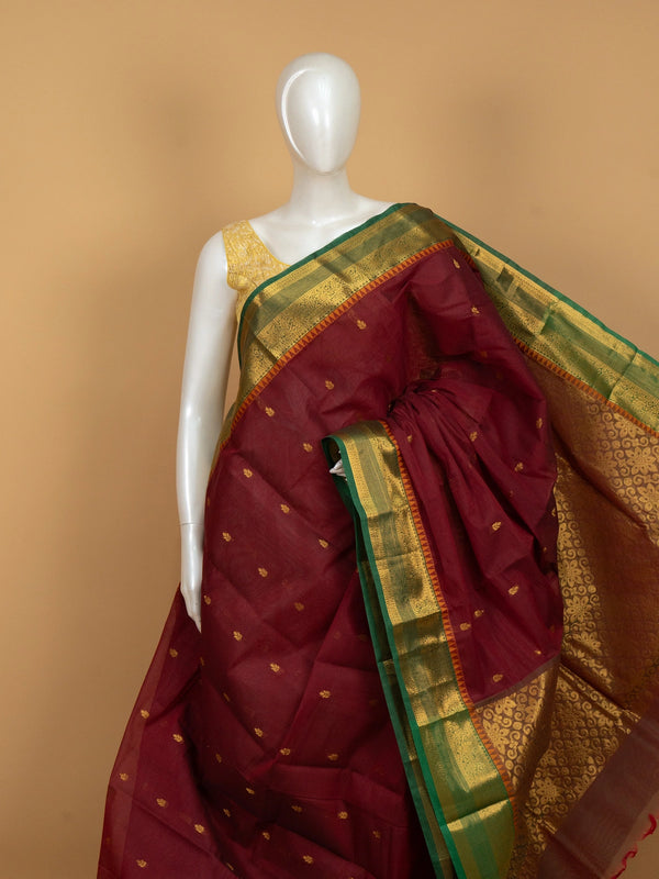 Maroon Chettinad cotton saree with green and gold zari contrast border and gold buttas