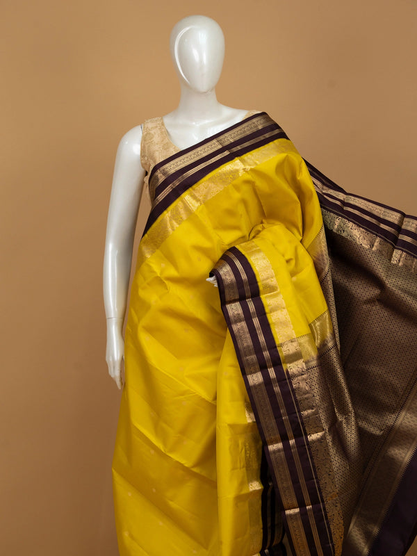 Yellow pure Kanchipuram silk saree with contrast wine border and gold zari brocade pallu