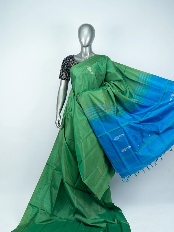Green banana silk saree with contrast blue pallu, silver paisley motifs and striped border