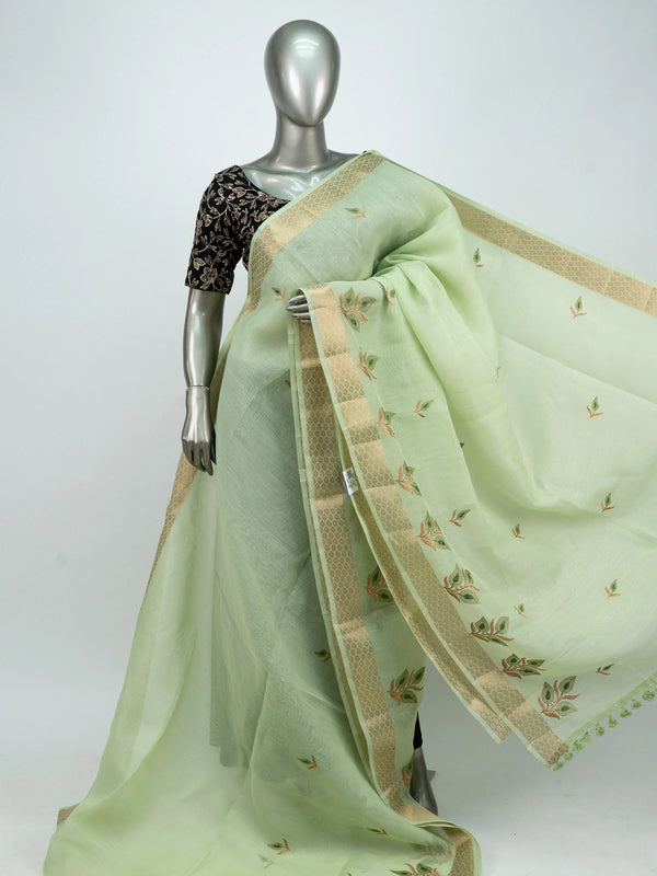 Pista green linen cotton saree with gold zari border, embroidered leaf buttas and contrast black embroidered blouse