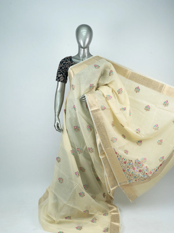 Cream linen cotton saree with gold zari border and multicoloured floral embroidered butas