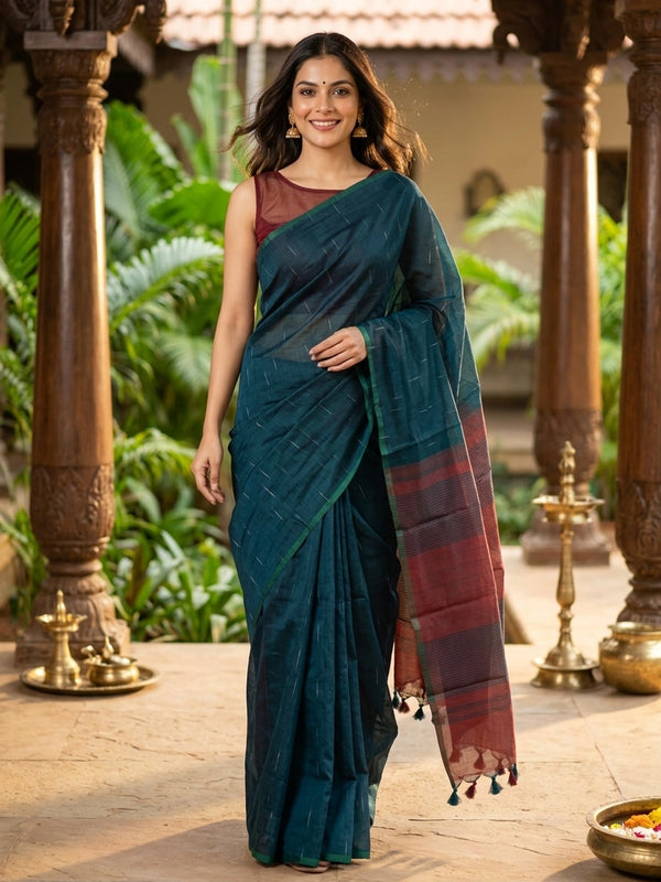 Teal green silk cotton saree with silver zari streaks and contrast maroon striped pallu