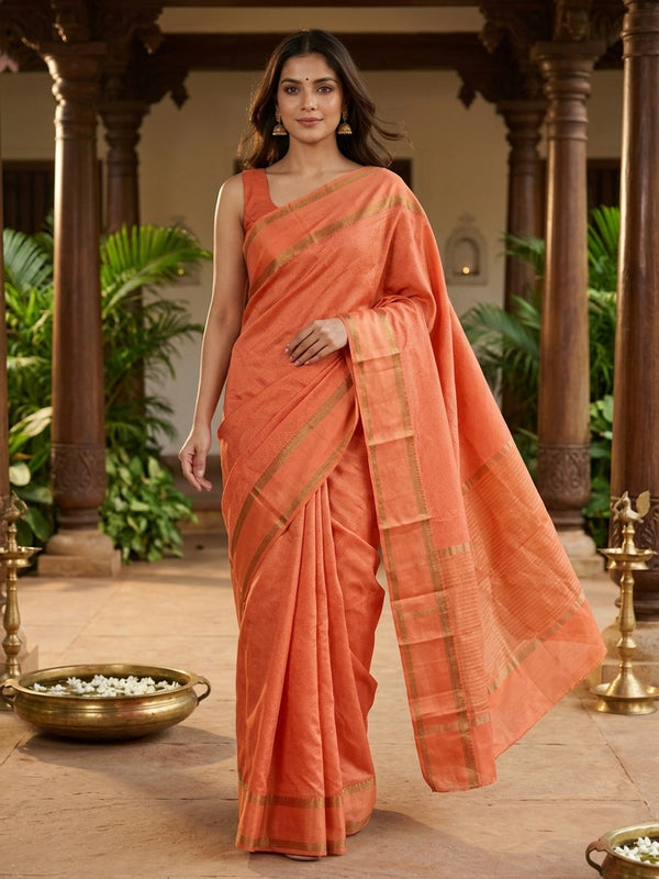 Orange semi tussar saree with gold zari border and geometric patterned body