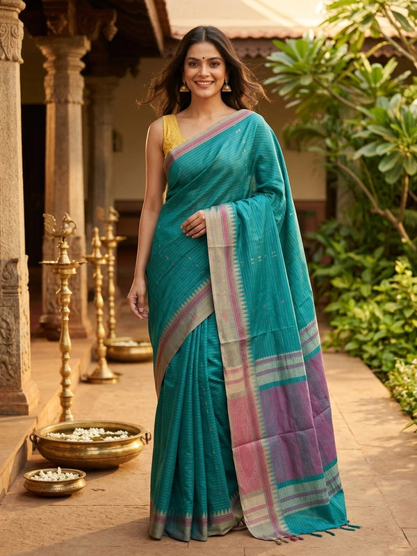 Teal green linen cotton saree with gold zari stripes, pink buti motifs and contrast grey temple border