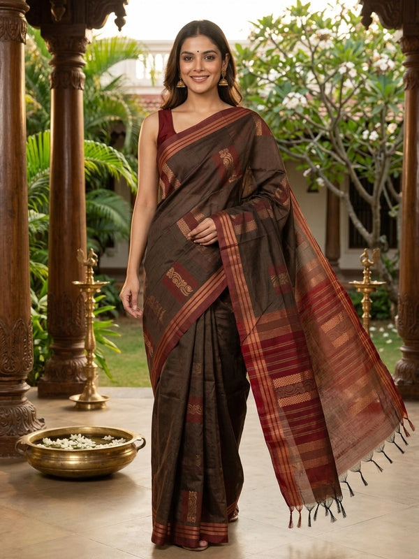 Brown silk cotton saree with contrast maroon border and copper zari butta motifs