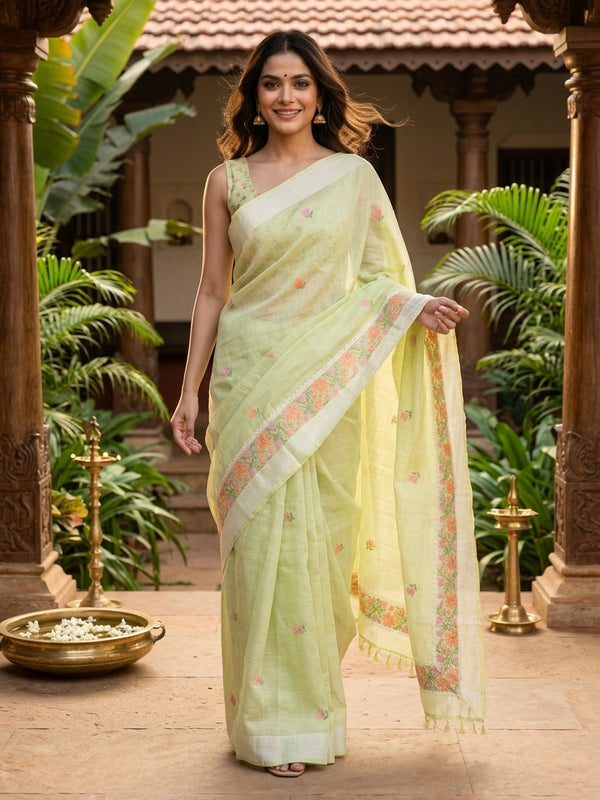 Pastel green linen cotton saree with pink and orange floral embroidery and cream contrast border