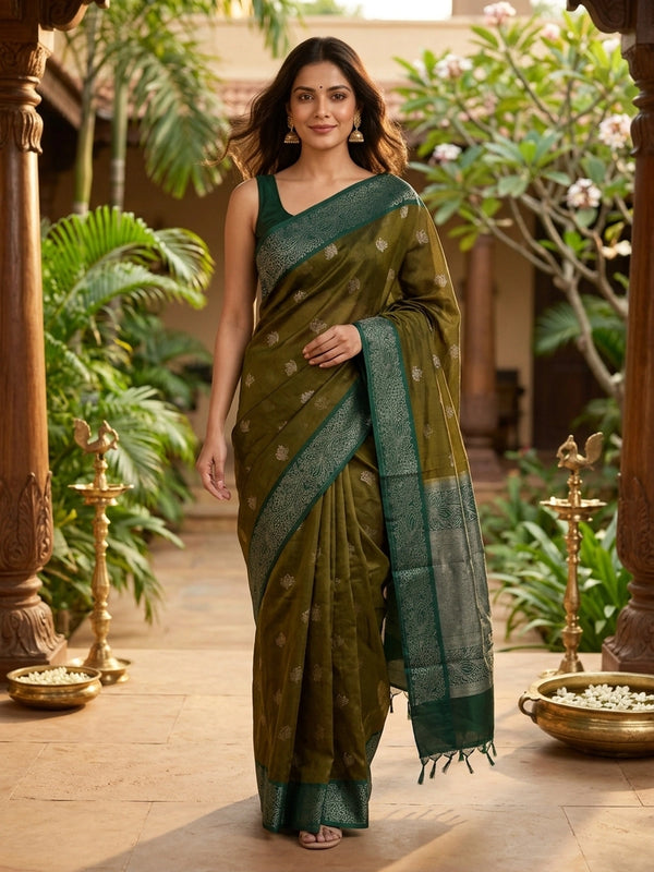 Mehendi green silk cotton saree with contrast bottle green zari border and silver lotus buttas