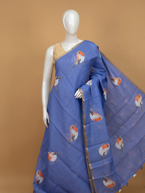 Periwinkle blue linen cotton saree with orange and white robin bird prints and a gold zari border