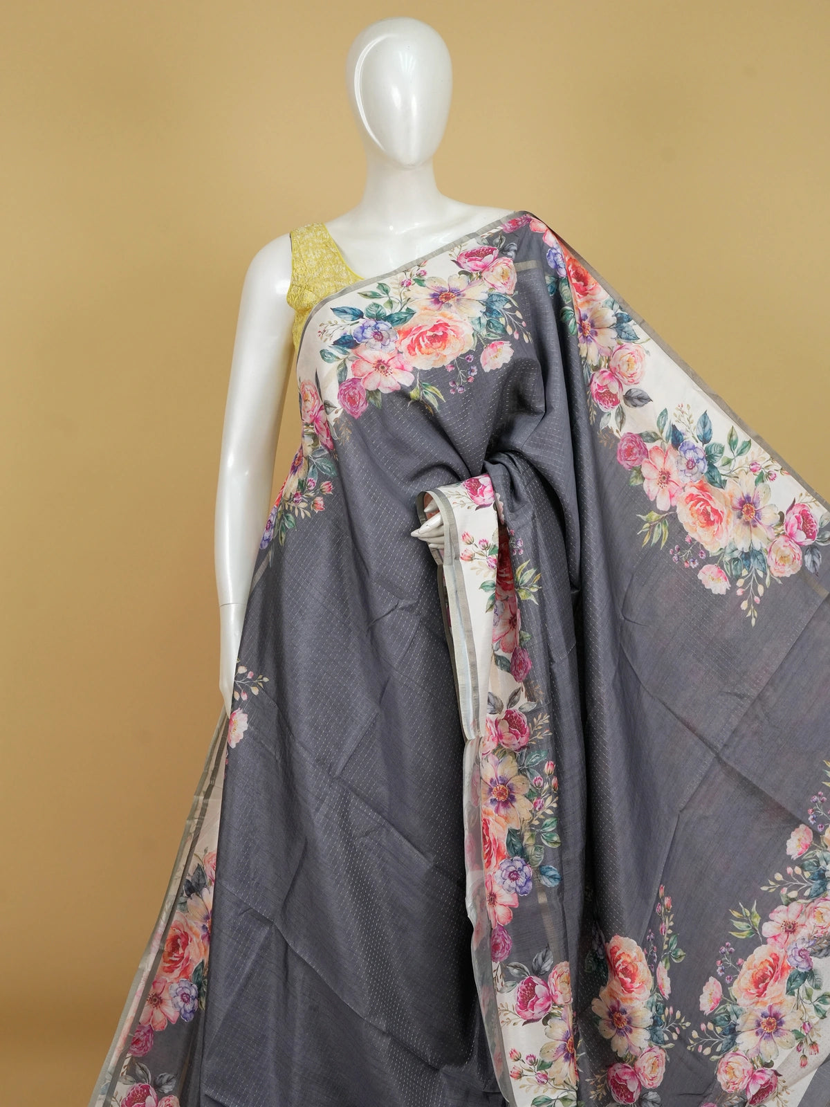 Grey semi tussar saree with cream floral borders, multicolour floral prints and a zari-dot textured body