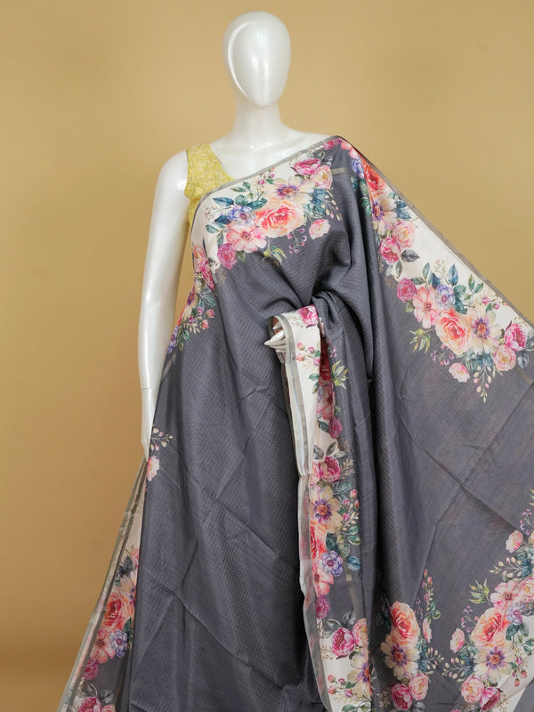 Grey semi tussar saree with cream floral borders, multicolour floral prints and a zari-dot textured body