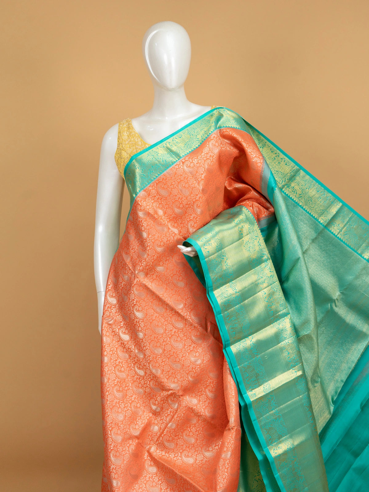 Coral orange pure Kanchipuram silk saree with teal green gold zari elephant border and matching blouse