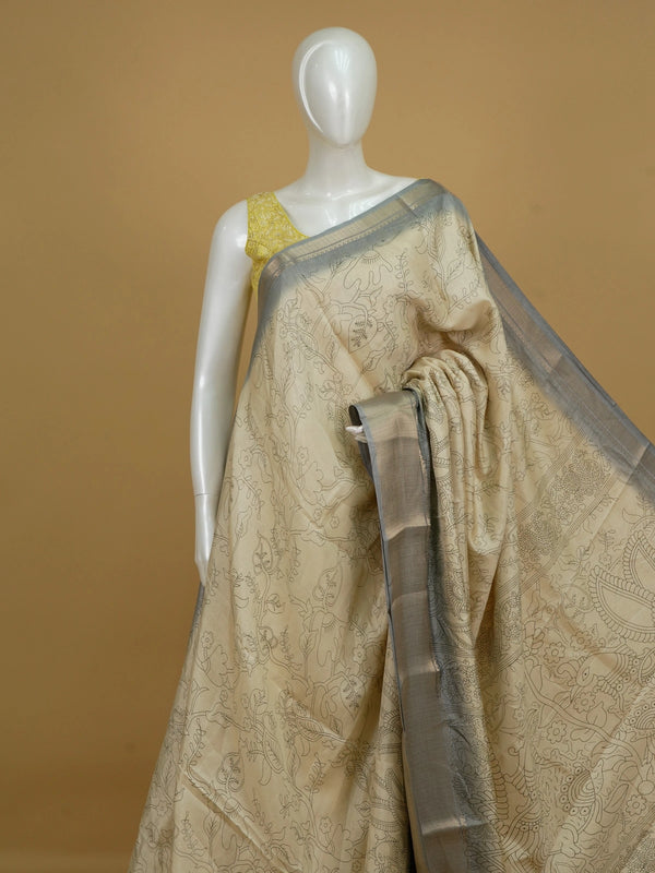 Beige Dola silk saree with Kalamkari peacock and floral motifs and contrast grey silver zari border