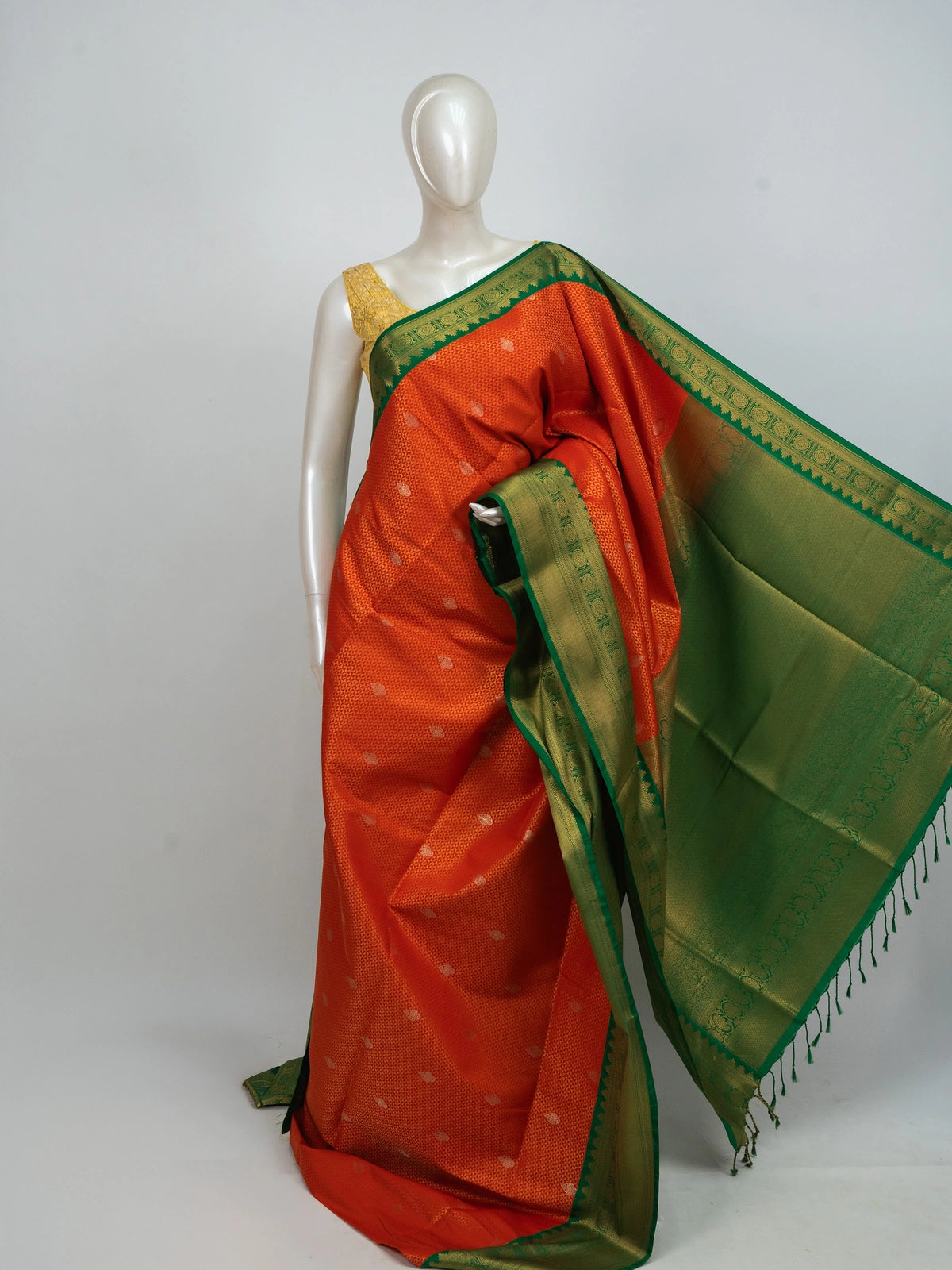 Orange Kanchipuram fancy silk saree with contrast green gold zari border and pallu