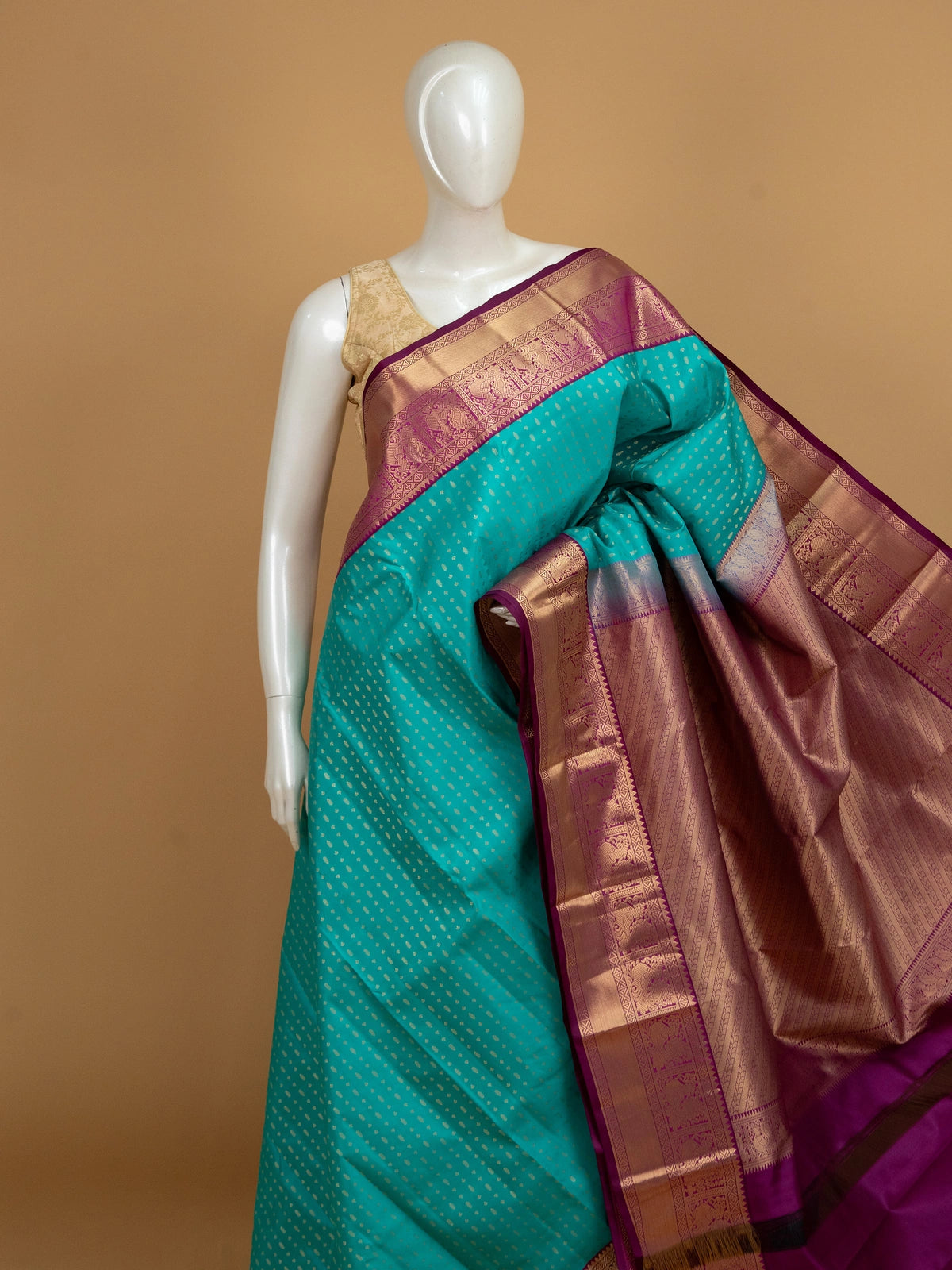 Teal pure Kanchipuram silk saree with gold zari butis and contrast magenta zari border and pallu