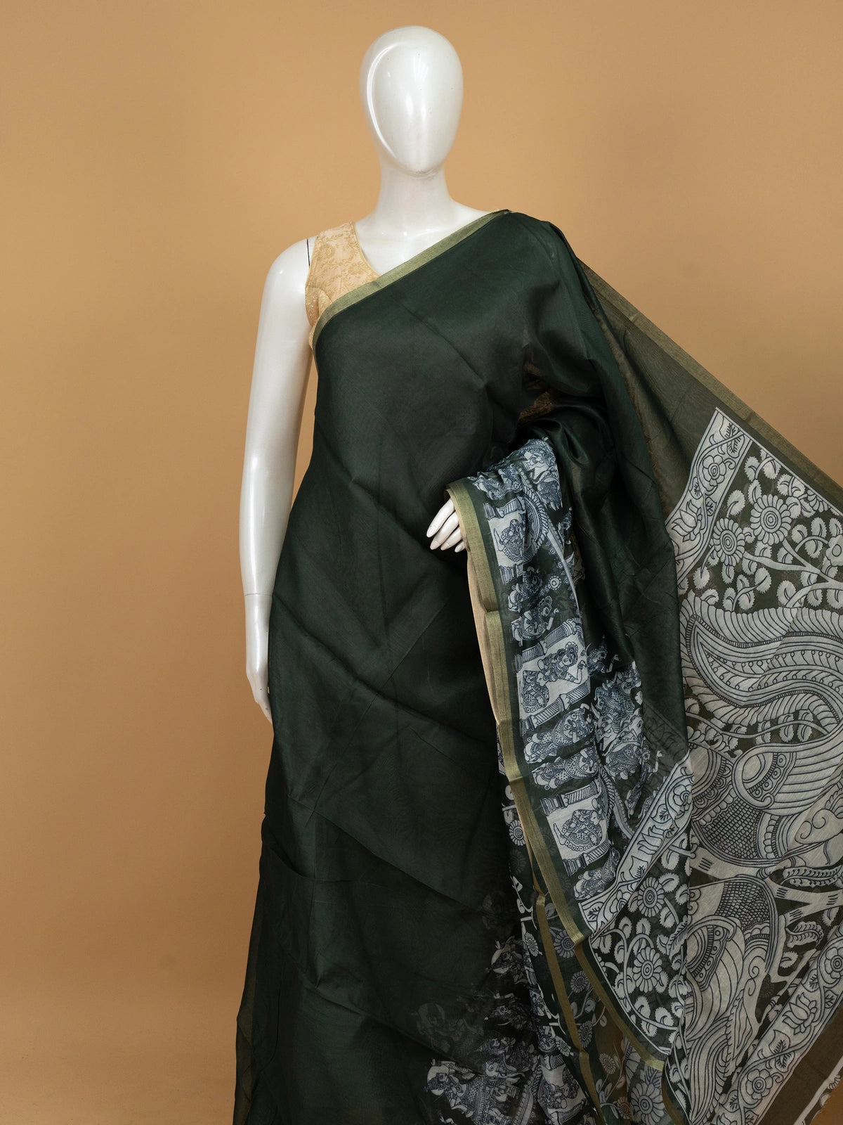 Dark green linen cotton saree with off-white Kalamkari peacock and floral printed pallu and gold zari border