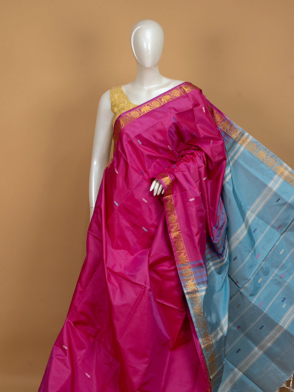 Pink banana silk saree with gold zari border, blue buti motifs and contrasting sky blue pallu